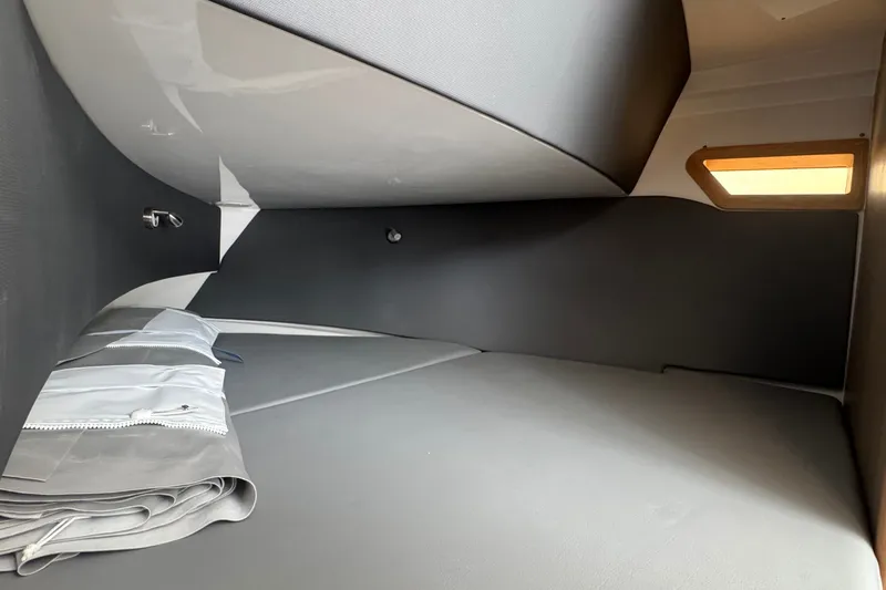 Slide: The Image of Interior cabin of 2027 Edgewater 310SC boat, featuring sleek design and comfortable bedding. - 41