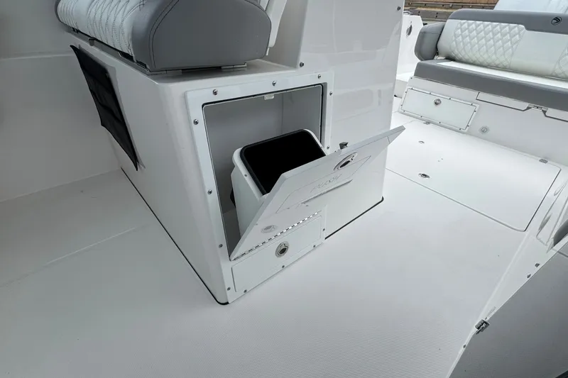 Slide: The Image of Edgewater 310SC 2027 boat interior with open storage compartment and seating. - 37
