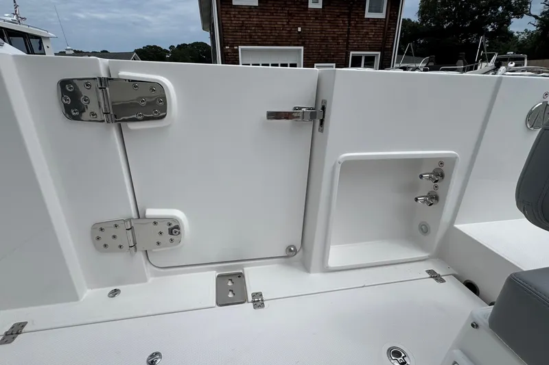 Slide: The Image of 2027 Edgewater 310SC boat interior with white door and stainless steel hinges. - 21