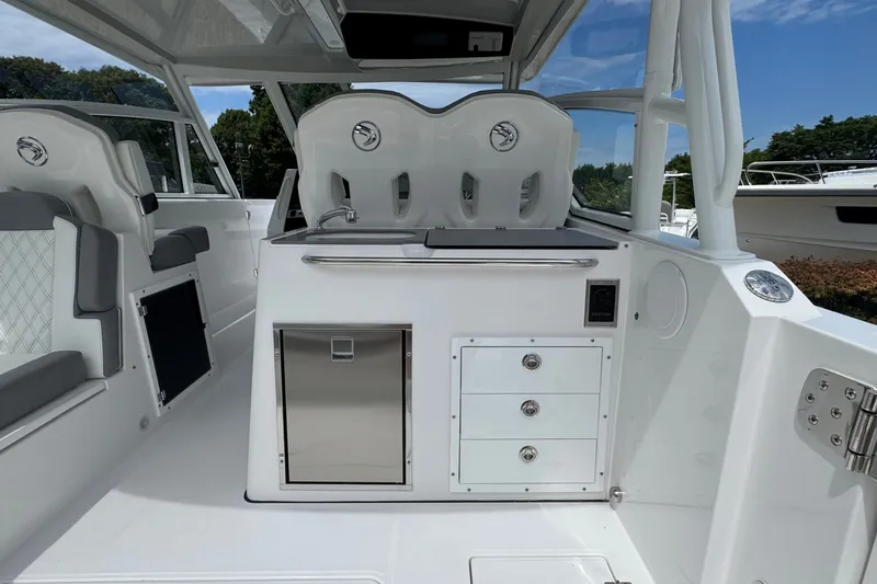 Slide: The Image of Edgewater 310SC 2027 boat interior with seating, storage, and sleek design. - 19
