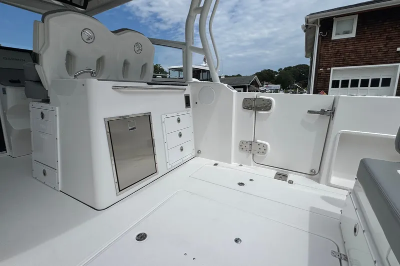 Slide: The Image of Interior of 2027 Edgewater 310SC boat, featuring seating and storage compartments. - 17