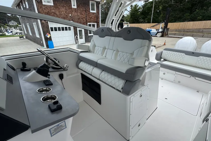 Slide: The Image of Interior of 2027 Edgewater 310SC boat with modern seating and steering console. - 32