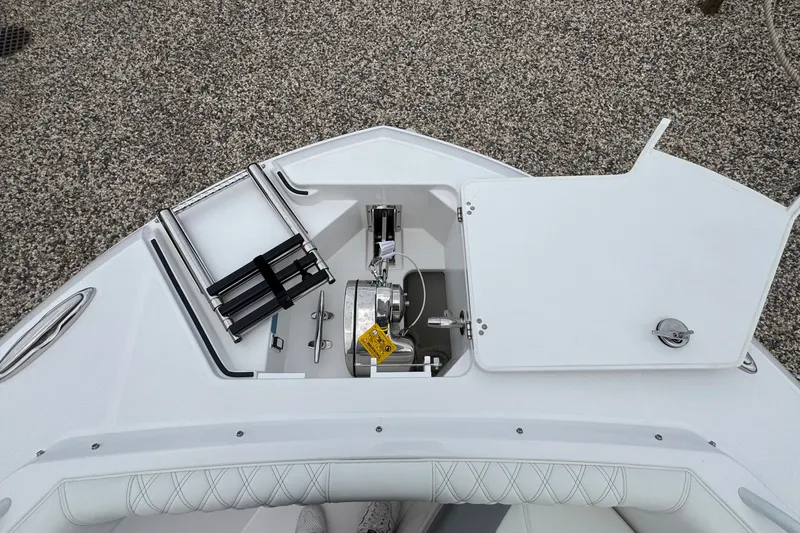 Slide: The Image of 2027 Edgewater 310SC boat anchor compartment with ladder and open hatch. - 55