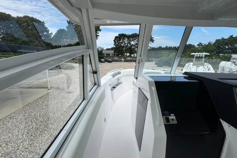 Slide: The Image of Interior view of 2027 Edgewater 310SC boat, showcasing sleek design and spacious cockpit. - 44