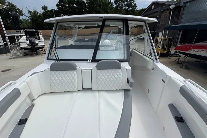 Slide: The Image of Edgewater 310SC 2027 boat interior with white seating and modern design. - 46