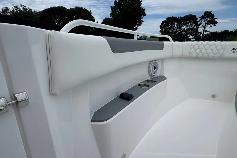 Slide: The Image of Interior view of 2027 Edgewater 310SC boat, featuring sleek seating and cup holders. - 49