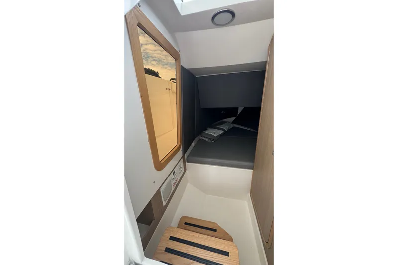 Slide: The Image of Interior cabin of 2027 Edgewater 310SC boat, featuring modern design and wooden accents. - 39