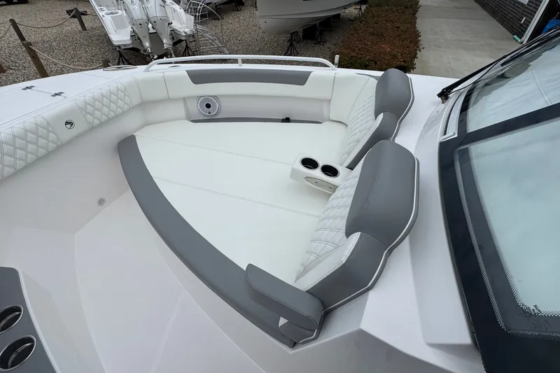 Slide: The Image of Luxurious seating area on 2027 Edgewater 310SC boat with cup holders and modern design. - 52