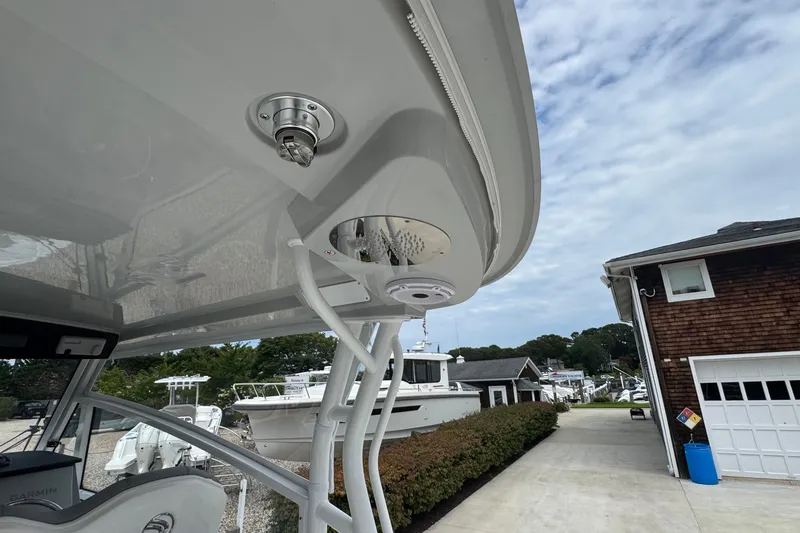Slide: The Image of Edgewater 310SC 2027 boat detail with marina background and clear sky. - 18