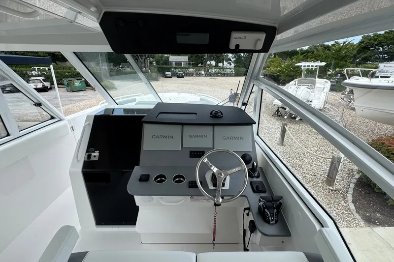 Slide: The Image of Interior view of 2027 Edgewater 310SC boat cockpit with Garmin navigation system. - 30