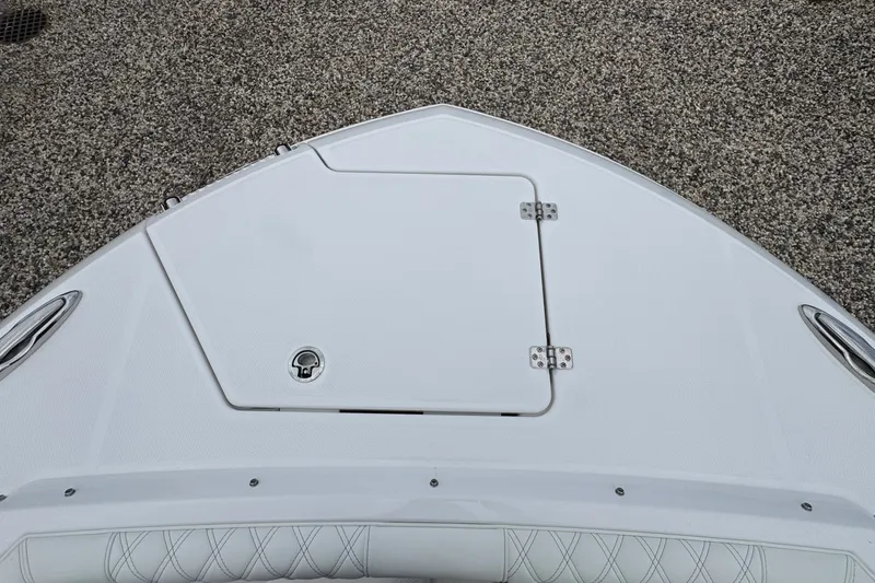 Slide: The Image of Bow of 2027 Edgewater 310SC boat with storage hatch and sleek design. - 54