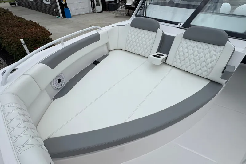 Slide: The Image of Luxurious seating on 2027 Edgewater 310SC boat with quilted upholstery and cup holders. - 50