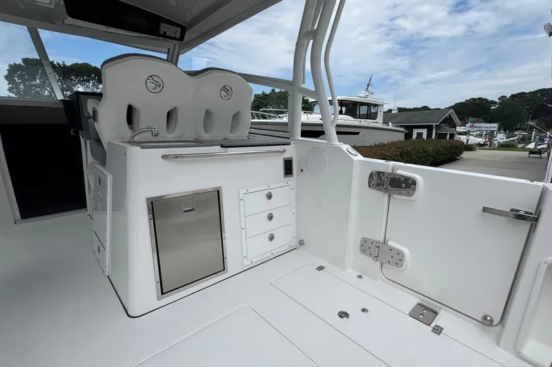 Slide: The Image of Interior of 2027 Edgewater 310SC boat featuring seating and storage compartments. - 15