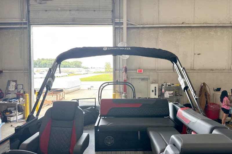 Slide: The Image of 2026 Godfrey Sweetwater 2286 SFL pontoon boat interior in a warehouse setting. - 15