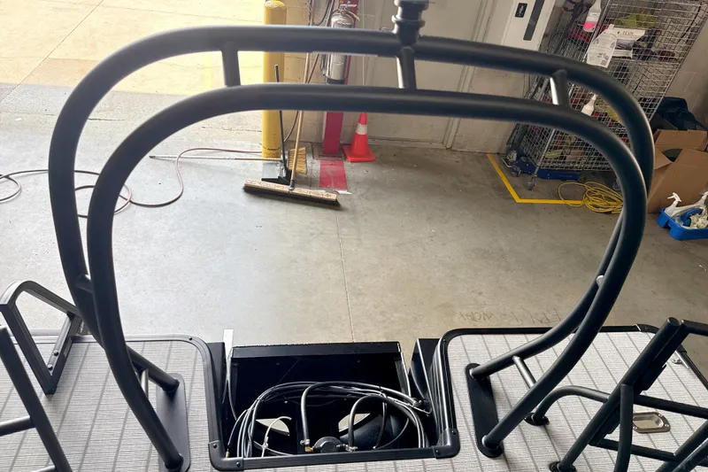 Slide: The Image of Rear view of 2026 Godfrey Sweetwater 2286 SFL boat ladder and deck in a garage. - 14