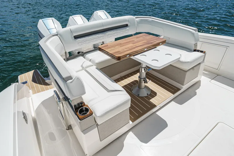 Slide: The Image of The 2024 Tiara Yachts 38 LS features a luxurious seating area with a wooden table and comfortable cushions. - 26