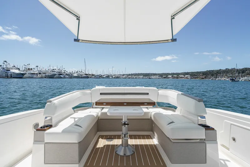 Slide: The Image of The image shows the stern of a 2024 Tiara Yachts 38 LS with luxurious seating and a table. - 30