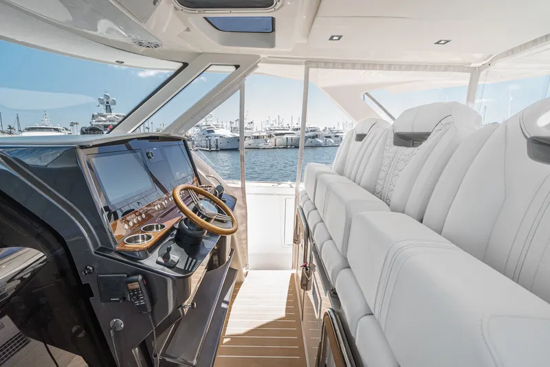 Slide: The Image of The image shows the cockpit of a 2024 Tiara Yachts 38 LS with luxurious white seating. - 44