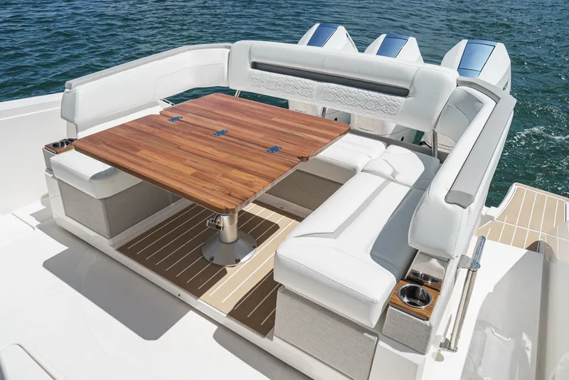 Slide: The Image of The 2024 Tiara Yachts 38 LS features an elegant seating area with a wooden table and white upholstery. - 28