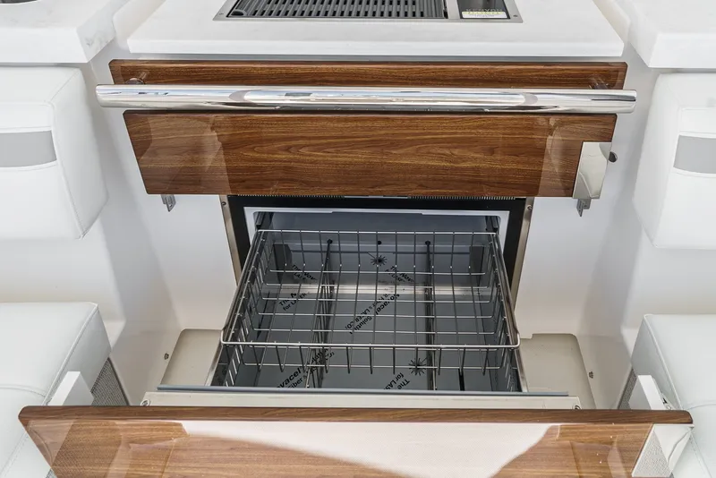 Slide: The Image of The 2024 Tiara Yachts 38 LS features a sleek kitchen with wooden cabinetry and a modern oven. - 39