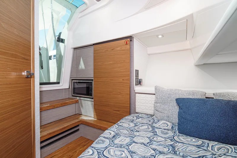 Slide: The Image of The 2024 Tiara Yachts 38 LS cabin features a cozy seating area with patterned cushions and wood accents. - 46