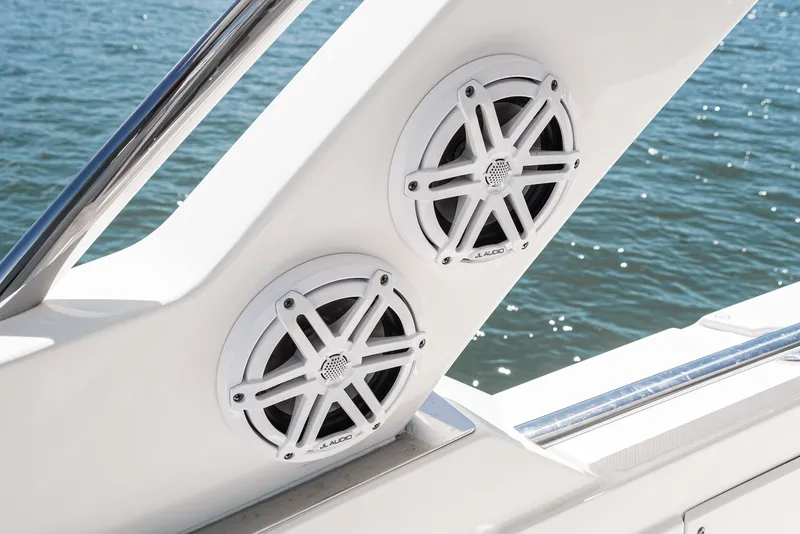 Slide: The Image of Two white speakers are integrated into the boat's wall, with water in the background. - 41