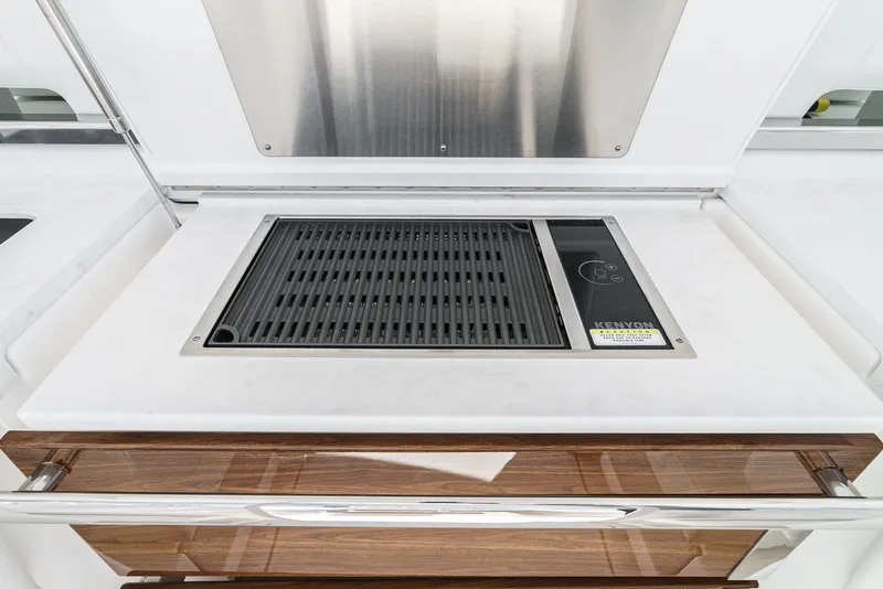 Slide: The Image of The 2024 Tiara Yachts 38 LS features a built-in Kenyon grill on a sleek countertop. - 38