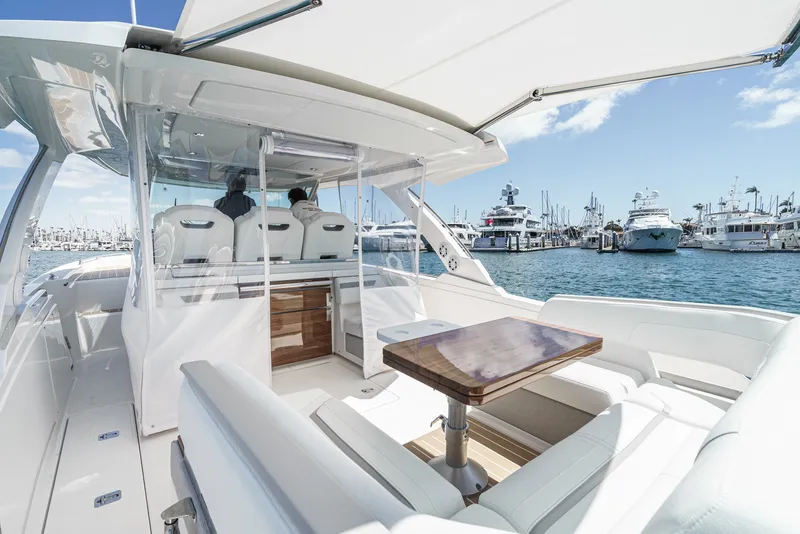 Slide: The Image of The image shows the deck of a 2024 Tiara Yachts 38 LS in a marina. - 33