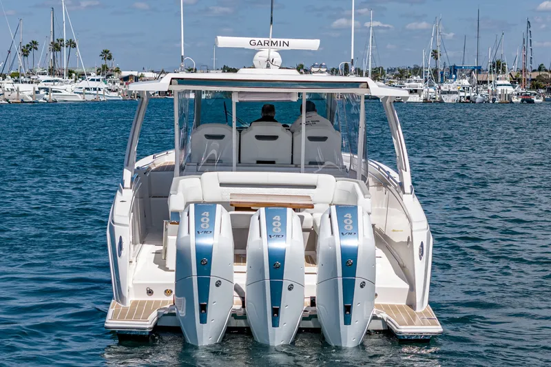 Slide: The Image of The 2024 Tiara Yachts 38 LS is a luxury motorboat with three powerful outboard engines. - 20