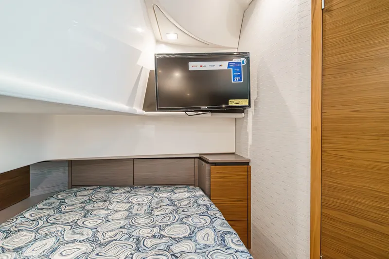 Slide: The Image of The cabin of the 2024 Tiara Yachts 38 LS features a bed and a television. - 49