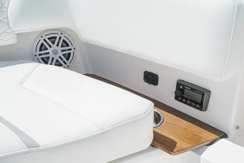 Slide: The Image of Close-up of a white seating area with speaker and controls on a 2024 Tiara Yachts 38 LS. - 17