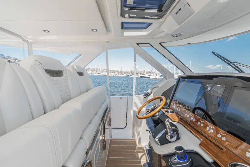 Slide: The Image of The cockpit of a 2024 Tiara Yachts 38 LS with luxurious seating and a modern helm station. - 45