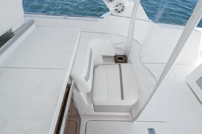 Slide: The Image of The 2024 Tiara Yachts 38 LS features an elegant white bench seat with a cup holder. - 40