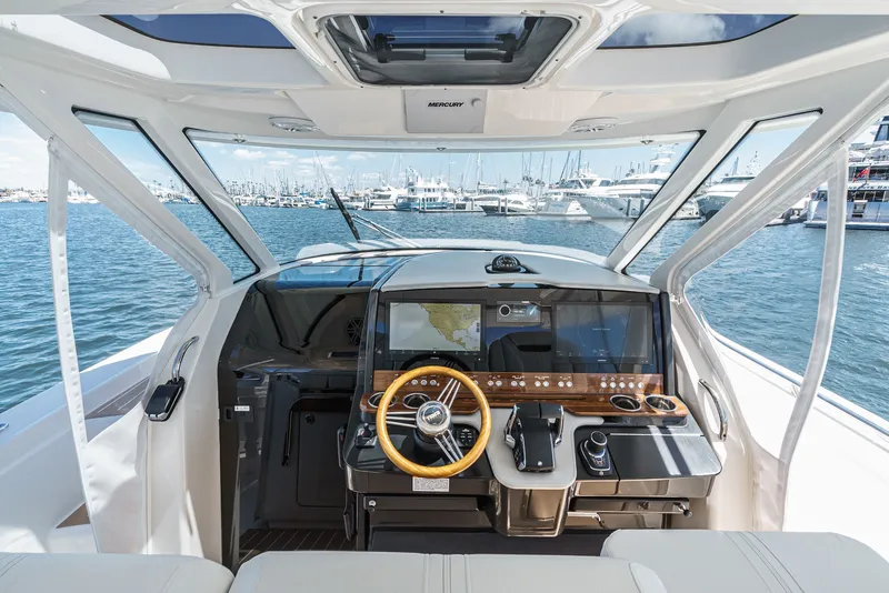 Slide: The Image of The 2024 Tiara Yachts 38 LS cockpit features a modern helm with a large display screen. - 42