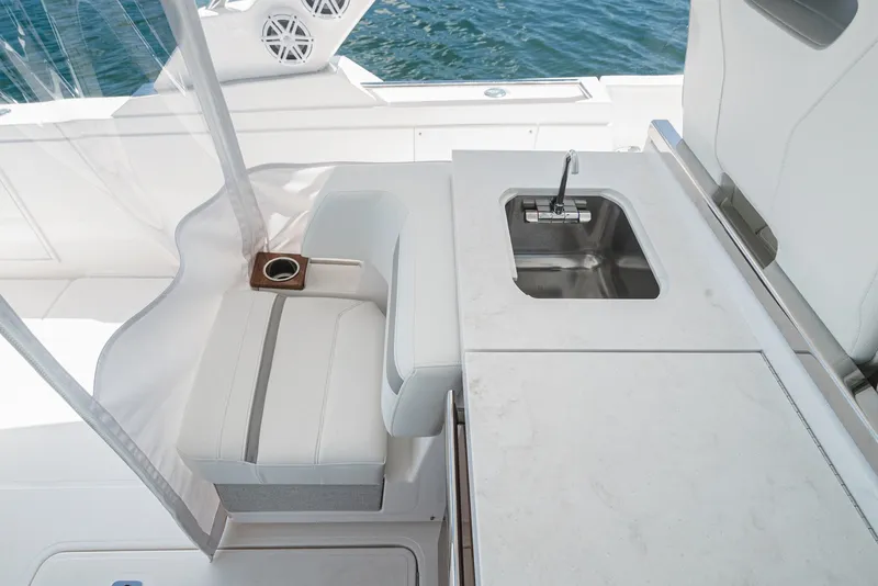 Slide: The Image of The 2024 Tiara Yachts 38 LS features a sleek seating area with a small sink. - 36