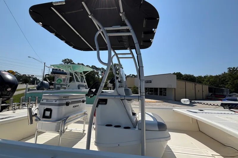 Slide: The Image of 2019 Mako Pro Skiff 19 CC boat with T-top and Igloo cooler on deck. - 20