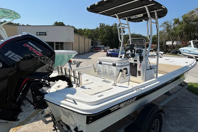 Slide: The Image of 2019 Mako Pro Skiff 19 CC boat with Mercury 115 Pro XS engine, parked outdoors. - 15