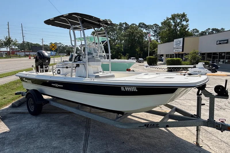 Slide: The Image of 2019 Mako Pro Skiff 19 CC boat on trailer, parked outdoors. - 14