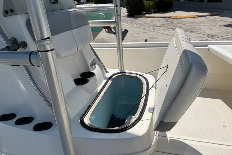 Slide: The Image of 2019 Mako Pro Skiff 19 CC boat interior with open storage compartment. - 23