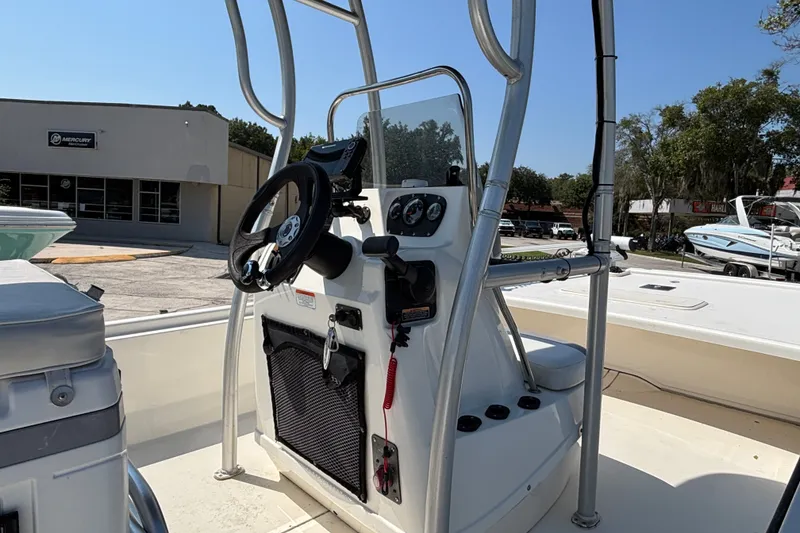 Slide: The Image of 2019 Mako Pro Skiff 19 CC boat console with steering wheel and controls. - 19