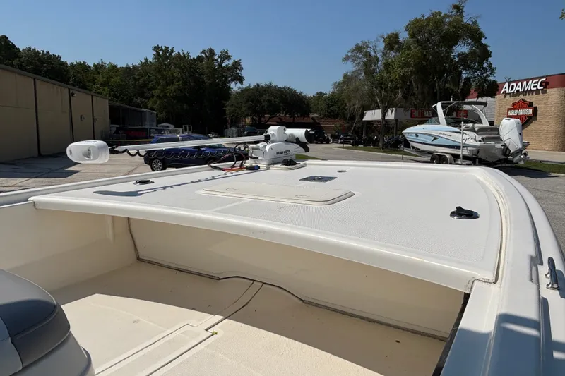 Slide: The Image of 2019 Mako Pro Skiff 19 CC boat with trolling motor in outdoor dealership setting. - 24