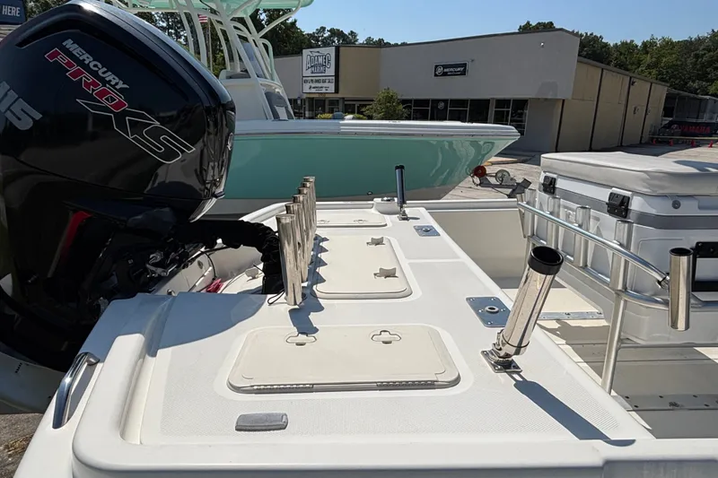 Slide: The Image of 2019 Mako Pro Skiff 19 CC boat with Mercury Pro XS engine, docked outdoors. - 16