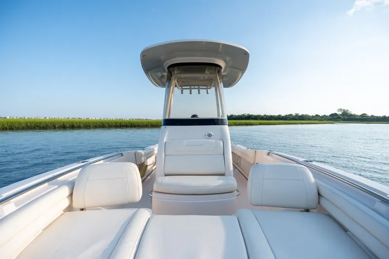 Slide: The Image of 2022 Grady-White Fisherman 216 boat on calm water, clear sky background. - 21