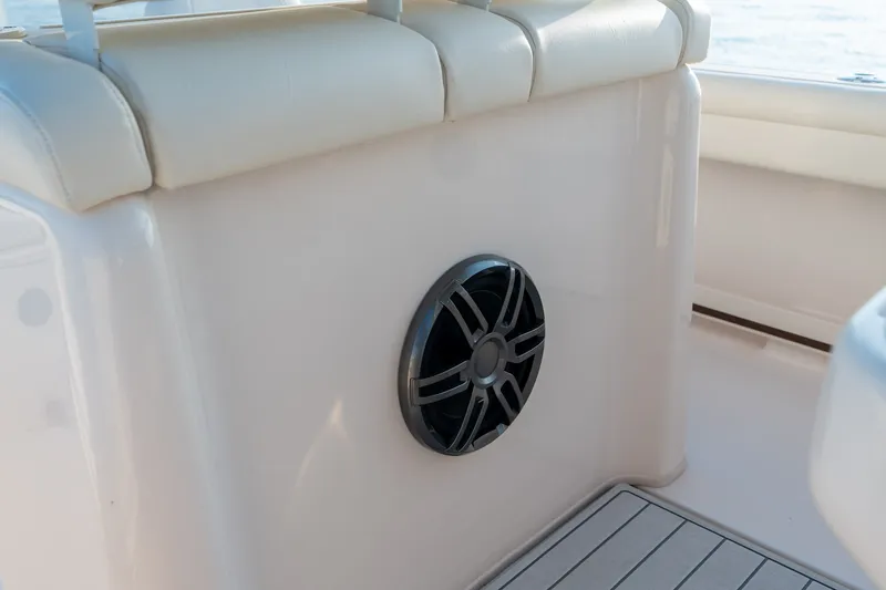 Slide: The Image of 2022 Grady-White Fisherman 216 boat interior with speaker and cushioned seating. - 16