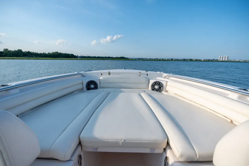 Slide: The Image of 2022 Grady-White Fisherman 216 boat interior with white seating on calm water. - 19