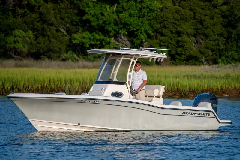 The Image of 2022 Grady-White Fisherman 216 boat cruising on a calm waterway with lush greenery. - 0