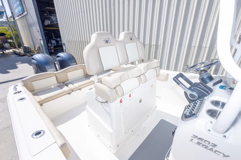 Slide: The Image of 2017 NauticStar 2602 Legacy boat interior with dual engines and comfortable seating. - 35