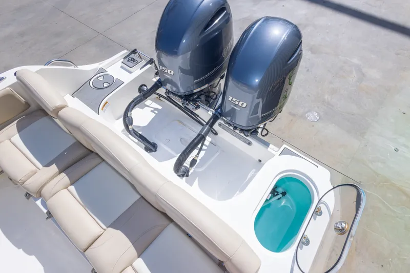 Slide: The Image of 2017 NauticStar 2602 Legacy boat with twin Yamaha 150 engines and beige seating. - 46