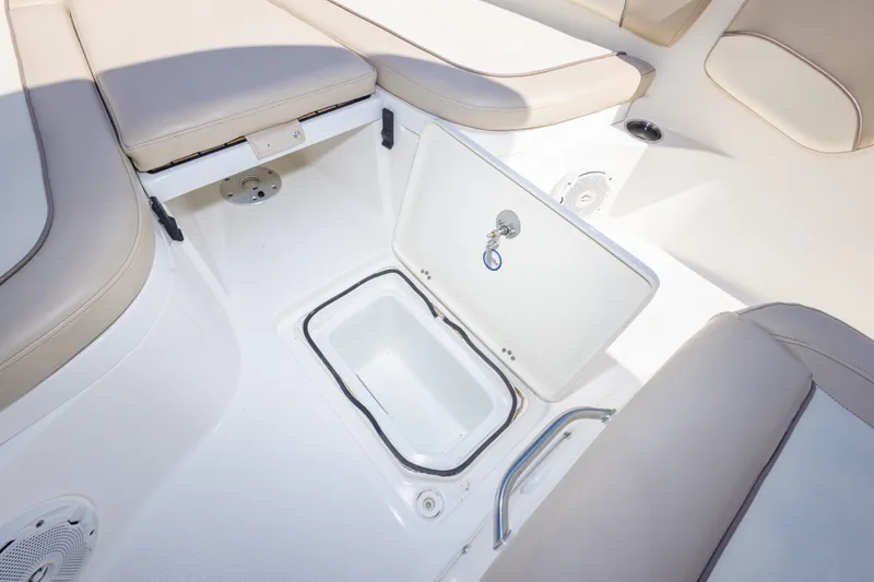 Slide: The Image of 2017 NauticStar 2602 Legacy boat interior with open storage compartment and cushioned seating. - 29