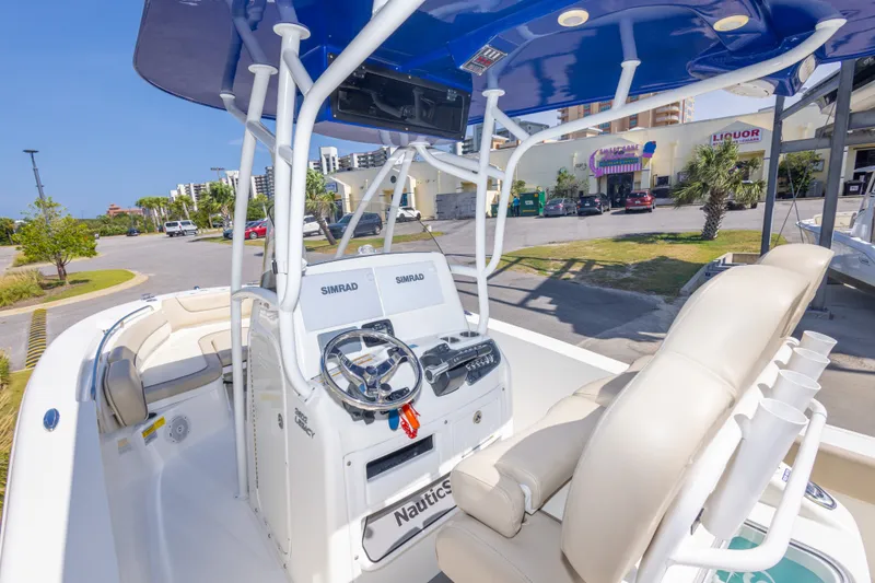 Slide: The Image of 2017 NauticStar 2602 Legacy boat interior with steering console and seating. - 18